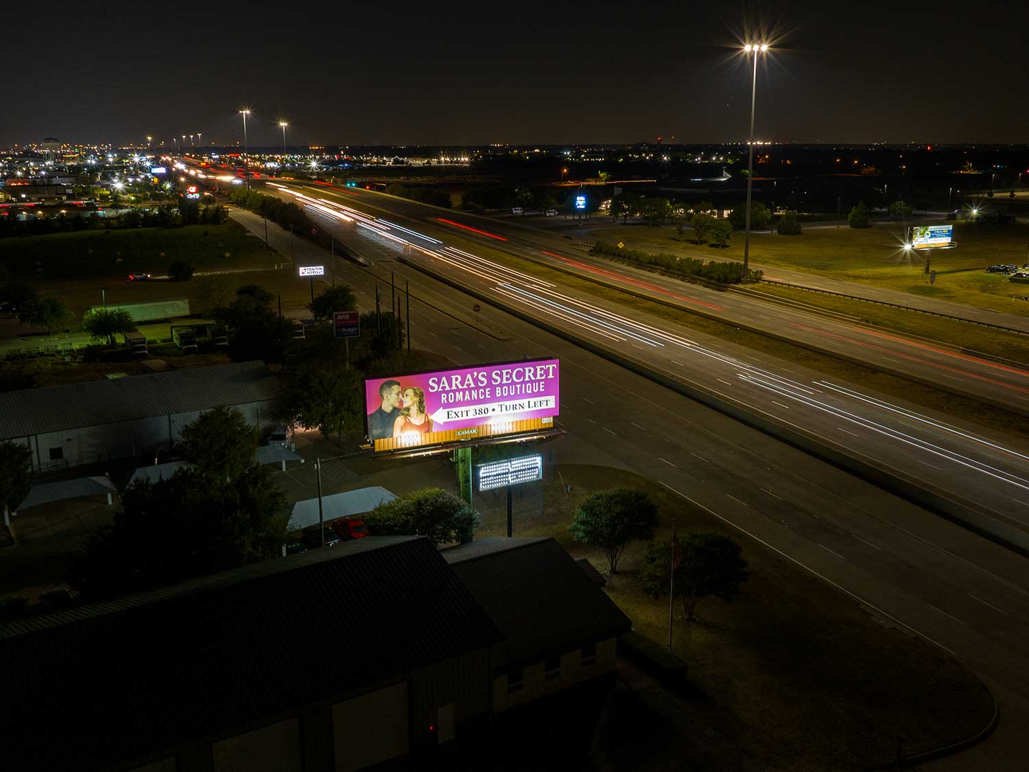 McKinney Static Directional Bulletin Billboard by Lamar Outdoor US 75 near Hwy 380 Drone Pic Nightlit